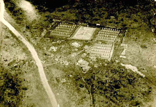 An aerial view of a military cemetary surrounded by forestry